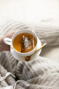 woman holding a cup of herbal tea