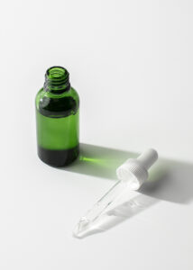 small green bottle of minerals with a dropper laying next to the bottle