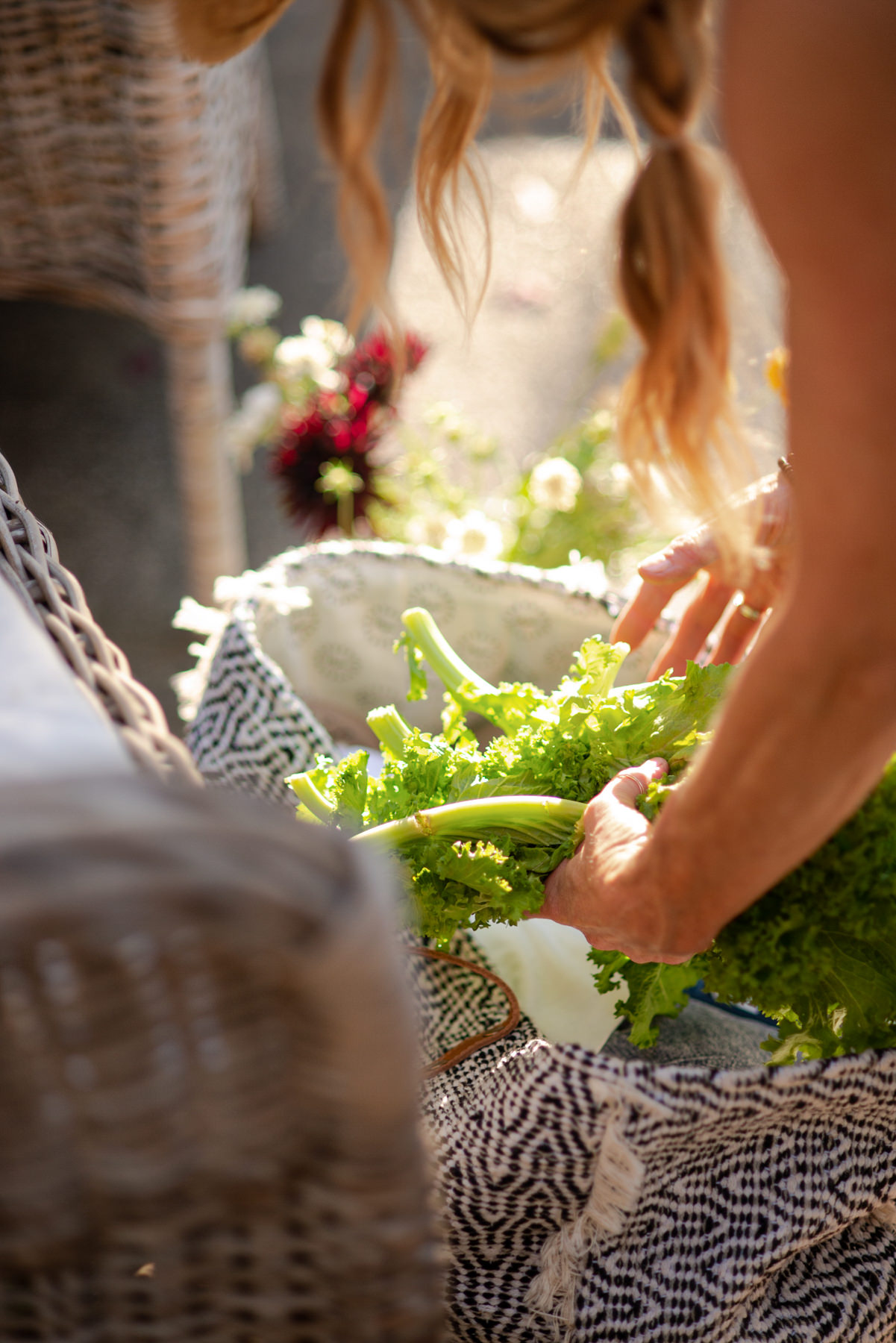 woman placing herbs in a basket, gut health starts with the food we eat